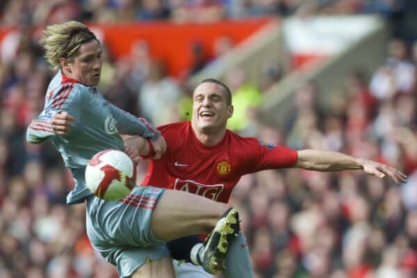 MANCHESTER, ENGLAND - Saturday, March 14, 2009: Liverpool's Fernando Torres powers past Manchester United's hapless Nemanja Vidic on his way to scoring the second goal during the Premiership match at Old Trafford. (Photo by David Rawcliffe/Propaganda)