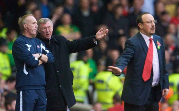 LIVERPOOL, ENGLAND - Sunday, October 25, 2009: Liverpool's manager Rafael Benitez organises his team, while Manchester United's manager Alex Ferguson tries to influence the fourth official, a tactic he uses when losing, during the Premiership match at Anfield. (Photo by David Rawcliffe/Propaganda)