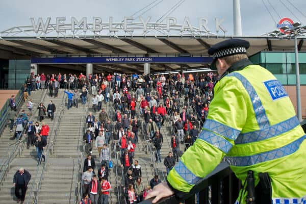 LONDON, ENGLAND - Saturday, April 14, 2012: A policeman watches Liverpool and Everton supporters arrive at Wembley Park Underground Station to watch the 218th Merseyside Derby, the FA Cup Semi-Final, at Wembley. (Pic by David Rawcliffe/Propaganda)