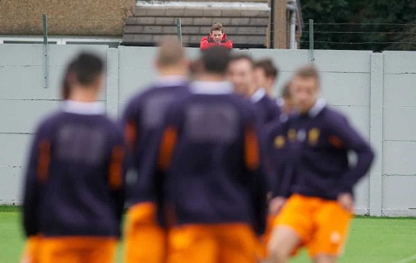 LIVERPOOL, ENGLAND - Wednesday, October 24, 2012: A young Liverpool supporter watches his heroes over the wall during a training session at Melwood Training Ground ahead of the UEFA Europa League Group A match against FC Anji Makhachkala. (Pic by David Rawcliffe/Propaganda)