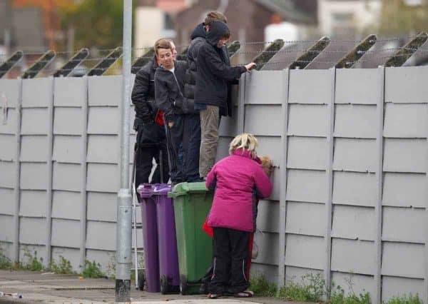 LIVERPOOL, ENGLAND - Wednesday, October 24, 2012: Liverpool supporters watch the players train over a wall during a training session at Melwood Training Ground ahead of the UEFA Europa League Group A match against FC Anji Makhachkala. (Pic by David Rawcliffe/Propaganda)