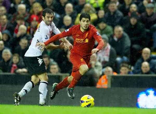 LIVERPOOL, ENGLAND - Saturday, December 22, 2012: Liverpool's Luis Alberto Suarez Diaz in action against Fulham's Giorgos Karagounis during the Premiership match at Anfield. (Pic by David Rawcliffe/Propaganda)