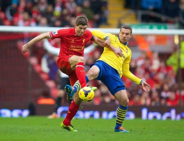 LIVERPOOL, ENGLAND - Saturday, February 8, 2014: Liverpool's captain Steven Gerrard in action against Arsenal'a Lukas Podolski during the Premiership match at Anfield. (Pic by David Rawcliffe/Propaganda)