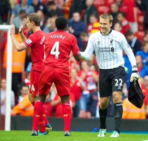 LIVERPOOL, ENGLAND - Saturday, August 17, 2013: Liverpool's goalkeeper Simon Mignolet celebrates with team-mate Kolo Toure after his last minute penalty save secured his side's 1-0 victory over Stoke City and putting his side top of the Premier League during the Premiership match at Anfield. (Pic by David Rawcliffe/Propaganda)