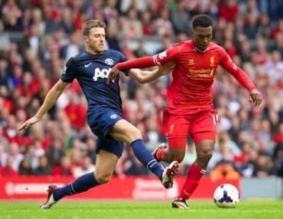 LIVERPOOL, ENGLAND - Sunday, September 1, 2013: Liverpool's Daniel Sturridge and Manchester United's Michael Carrick during the Premiership match at Anfield. (Pic by David Rawcliffe/Propaganda)