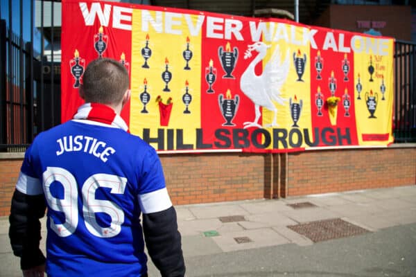 LIVERPOOL, ENGLAND - Tuesday, April 15, 2014: An Everton supporter looks on at a large banner with the names of the 96 victims of the Hillsborough Disaster embodied before the 25th Anniversary Hillsborough Service at Anfield. (Pic by David Rawcliffe/Propaganda)