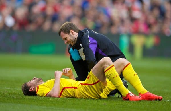 DUBLIN, REPUBLIC OF IRELAND - Wednesday, May 14, 2014: Liverpool's Fabio Borini lies injured with physiotherapist Chris Morgan during a postseason friendly match against Shamrock Rovers at Lansdowne Road. (Pic by David Rawcliffe/Propaganda)