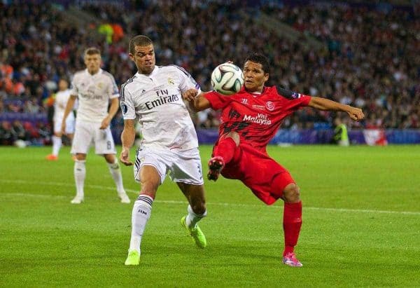 CARDIFF, WALES - Tuesday, August 12, 2014: Sevilla's Carlos Bacca in action against Real Madrid's Pepe during the UEFA Super Cup at the Cardiff City Stadium. (Pic by David Rawcliffe/Propaganda)