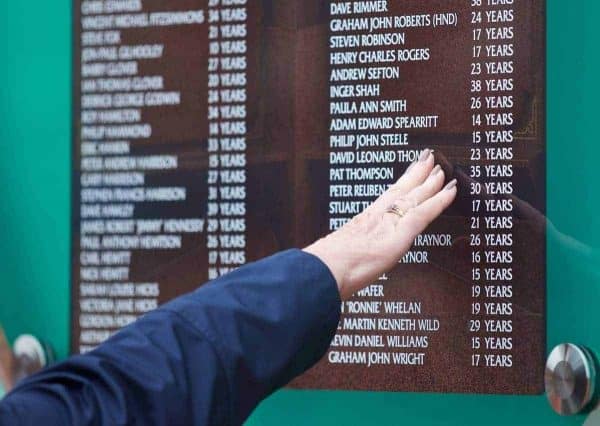 LIVERPOOL, ENGLAND - Wednesday, April 15, 2015: A supporter touches the temporary Memorial before the 26th Anniversary Hillsborough Service at Anfield. (Pic by David Rawcliffe/Propaganda)