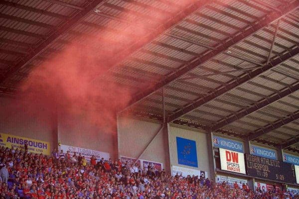 WIGAN, ENGLAND - Sunday, July 17, 2016: Liverpool supporters set off red smoke bombs as they celebrate the first goal against Wigan Athletic during a pre-season friendly match at the DW Stadium. (Pic by David Rawcliffe/Propaganda)