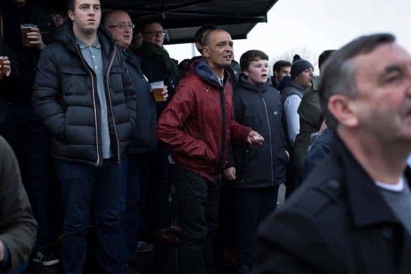 Home supporters in the shed watching the early action at the Delta Taxis Stadium, Bootle, Merseyside as City of Liverpool hosted Holker Old Boys in a North West Counties League division one match. Founded in 2015, and aiming to be the premier non-League club in Liverpool, City were admitted to the League at the start of the 2016-17 season and were using Bootle FC's ground for home matches. A 6-1 victory over their visitors took 'the Purps' to the top of the division, in a match watched by 483 spectators.