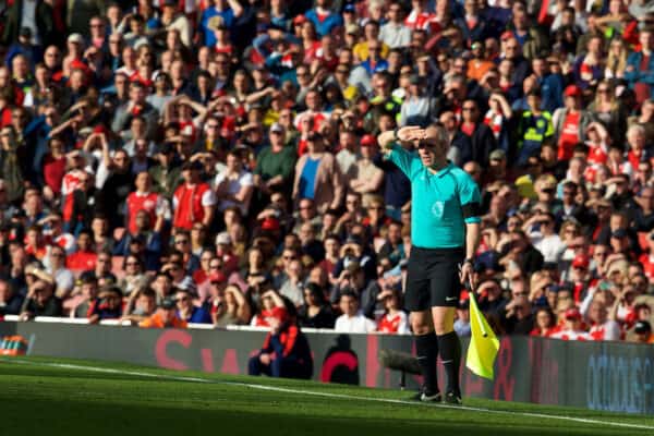 LONDON, ENGLAND - Sunday, April 2, 2017: Assistant linesman shields his eyes from the sun during the FA Premier League match between Arsenal and Manchester City at the Emirates Stadium. (Pic by David Rawcliffe/Propaganda)