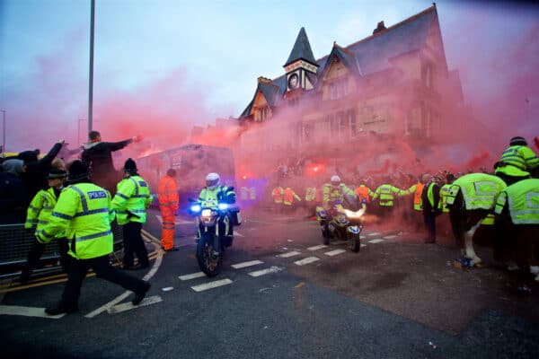 LIVERPOOL, ENGLAND - Wednesday, April 4, 2018: Merseyside police officers escort the Manchester City team coach through red smoke bombs and flares at the Arkles Pub as Liverpool supporters give the team a warm welcome before the UEFA Champions League Quarter-Final 1st Leg match between Liverpool FC and Manchester City FC at Anfield. (Pic by David Rawcliffe/Propaganda)