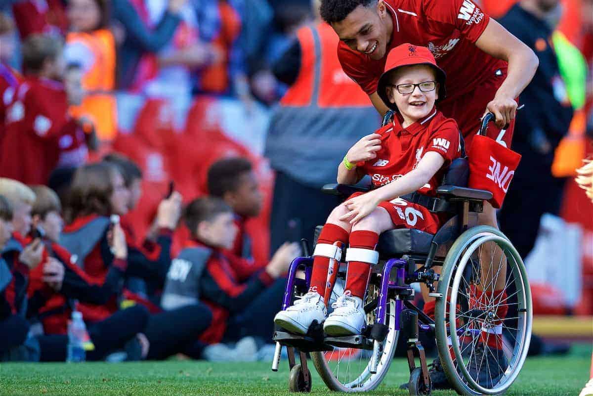 LIVERPOOL, ENGLAND - Sunday, May 13, 2018: Liverpool's Trent Alexander-Arnold pushes a wheelchair with young supporter Louis as the players perform a lap of honour after the FA Premier League match between Liverpool FC and Brighton & Hove Albion FC at Anfield. Liverpool won 4-0 and finished 4th. (Pic by David Rawcliffe/Propaganda)