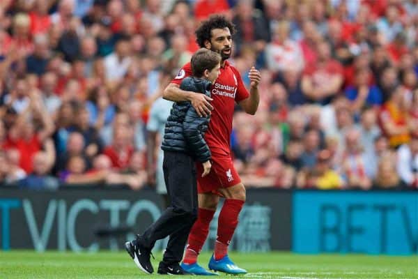 LIVERPOOL, ENGLAND - Sunday, August 12, 2018: A young Liverpool supporter runs onto the field to hug Mohamed Salah during the FA Premier League match between Liverpool FC and West Ham United FC at Anfield. (Pic by David Rawcliffe/Propaganda)