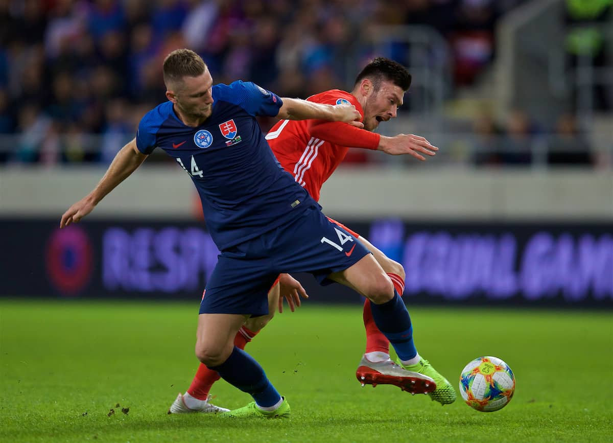 TRNAVA, SLOVAKIA - Thursday, October 10, 2019: Slovakia's Milan Škriniar (L) challenges Wales' Kieffer Moore during the UEFA Euro 2020 Qualifying Group E match between Slovakia and Wales at the Štadión Antona Malatinského. (Pic by David Rawcliffe/Propaganda)