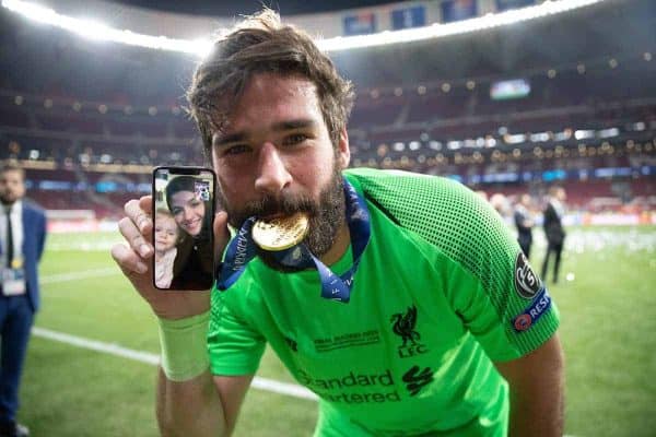 MADRID, SPAIN - SATURDAY, JUNE 1, 2019: Liverpool's goalkeeper Alisson Becker celebrates by biting his medal and FaceTiming his wife and family after the UEFA Champions League Final match between Tottenham Hotspur FC and Liverpool FC at the Estadio Metropolitano. Liverpool won 2-0 to win their sixth European Cup. (Pic by Peter Makadi/Propaganda)