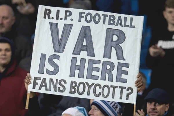 MANCHESTER, ENGLAND - Wednesday, January 1, 2020: A supporter holds up a sign "RIP football VAR is here. Fans Boycott?" as two stewards stand over him during the FA Premier League match between Manchester City FC and Everton FC at the City of Manchester Stadium. (Pic by David Rawcliffe/Propaganda)