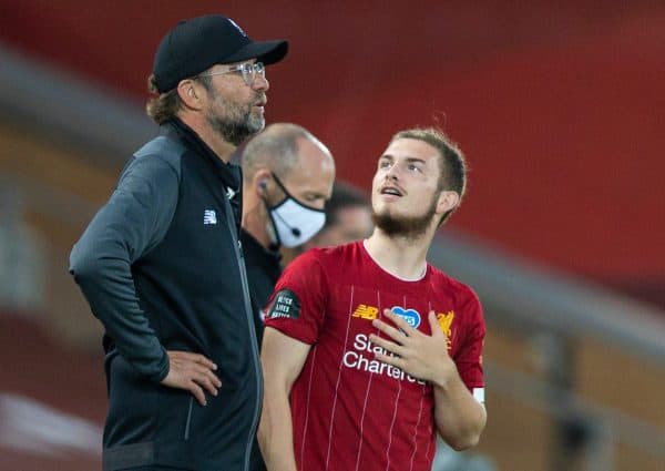 LIVERPOOL, ENGLAND - Wednesday, June 24, 2020: Liverpool’s Harvey Elliott looks up towards the tall presence of manager Jürgen Klopp as he prepares to come on as a substitute during the FA Premier League match between Liverpool FC and Crystal Palace FC at Anfield. The game was played behind closed doors due to the UK government’s social distancing laws during the Coronavirus COVID-19 Pandemic. (Pic by David Rawcliffe/Propaganda)