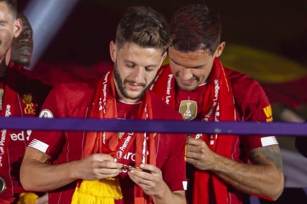 LIVERPOOL, ENGLAND - Wednesday, July 22, 2020: Liverpool's Adam Lallana looks at his winners' medal during the trophy presentation as the Reds are crowned Champions after the FA Premier League match between Liverpool FC and Chelsea FC at Anfield. The game was played behind closed doors due to the UK government’s social distancing laws during the Coronavirus COVID-19 Pandemic. Roberto Firmino, Joel Matip, Dejan Lovren, goalkeeper Caoimhin Kelleher, Mohamed Salah, Georginio Wijnaldum, Virgil van Dijk, Joe Gomez. (Pic by David Rawcliffe/Propaganda)