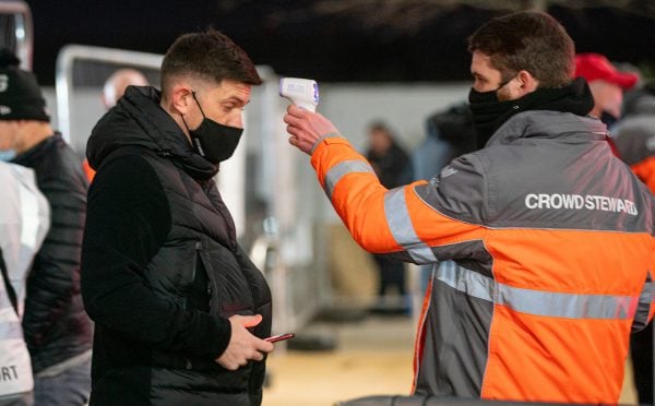 LIVERPOOL, ENGLAND - Sunday, December 6, 2020: A Liverpool supporter has his temperature checked as the club welcomes 2,000 spectators back into the stadium, pictured before the FA Premier League match between Liverpool FC and Wolverhampton Wanderers FC at Anfield. Liverpool won 4-0. (Pic by David Rawcliffe/Propaganda)