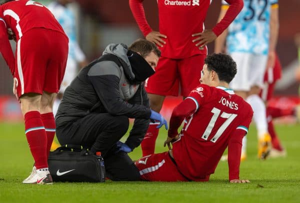 LIVERPOOL, ENGLAND - Sunday, December 6, 2020: Liverpool's Curtis Jones receives treatment from physio Chris Morgan during the FA Premier League match between Liverpool FC and Wolverhampton Wanderers FC at Anfield. Liverpool won 4-0. (Pic by David Rawcliffe/Propaganda)