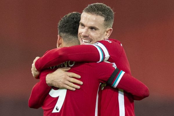 LIVERPOOL, ENGLAND - Wednesday, December 16, 2020: Liverpool's captain Jordan Henderson celebrates with match-winning goal-scorer Roberto Firmino (L) at the final whistle during the FA Premier League match between Liverpool FC and Tottenham Hotspur FC at Anfield. Liverpool won 2-1. (Pic by David Rawcliffe/Propaganda)