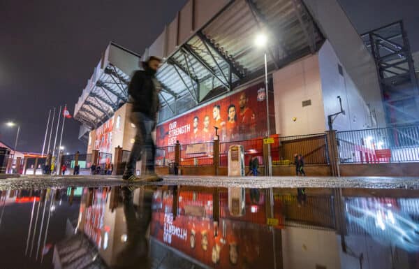 LIVERPOOL, ENGLAND - Wednesday, December 22, 2021: A man walks past a puddle reflecting images of Liverpool players outside the Spion Kop stand before the Football League Cup Quarter-Final match between Liverpool FC and Leicester City FC at Anfield. Liverpool won 5-4 on penalties after a 3-3 draw. (Pic by David Rawcliffe/Propaganda)