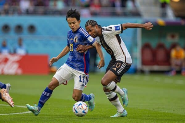 DOHA, QATAR - Wednesday, November 23, 2022: Japan's Takefusa Kubo (L) is challenged by Germany's Serge Gnabry during the FIFA World Cup Qatar 2022 Group E match between Germany and Japan at the Khalifa International Stadium. (Pic by David Rawcliffe/Propaganda)
