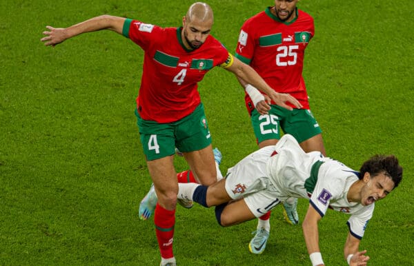 DOHA, QATAR - Saturday, December 10, 2022: Portugal's João Félix (C) is challenged by Morocco's Sofyan Amrabat (L) and Yahia Attiat-Allah during the FIFA World Cup Qatar 2022 Quarter-Final match between Morocco and Portugal at the Al Thumama Stadium. Morocco won 1-0. (Pic by David Rawcliffe/Propaganda)