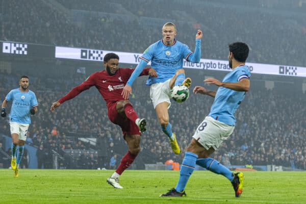 MANCHESTER, ENGLAND - Thursday, December 22, 2022: Manchester City's Erling Haaland beats Liverpool's Joe Gomez to the ball as he scores the opening goal during the Football League Cup 4th Round match between Manchester City FC and Liverpool FC at the City of Manchester Stadium. Manchester City won 3-2. (Pic by David Rawcliffe/Propaganda)