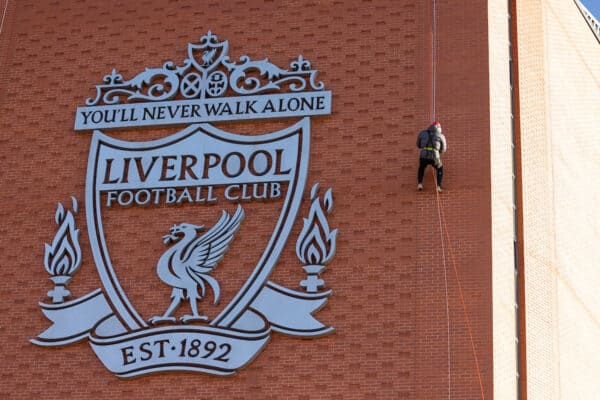 LIVERPOOL, ENGLAND - Thursday, February 9, 2023: A man walks down the side of the Main Stand past a huge Liverpool FC crest as he takes part in the Anfield Abseil Experience. (Pic by David Rawcliffe/Propaganda)