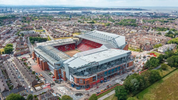 LIVERPOOL, ENGLAND - Friday, July 7, 2023: An aerial view of Anfield, the home stadium of Liverpool Football Club, showing the ongoing construction of the new Anfield Road expansion. The redevelopment of the stand will see 7,000 more seats added taking Anfield's overall capacity to more than 61,000. The construction of Everton Football Club's new stadium at Bramley-Moore Dock dock can be seen in the background. (Pic by David Rawcliffe/Propaganda)