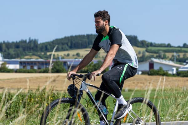 DONESCHINGEN, GERMANY - Tuesday, July 18, 2023: Liverpool's goalkeeper Alisson Becker rides to a training session on a bike during a pre-season training camp in Germany. (Pic by David Rawcliffe/Propaganda)