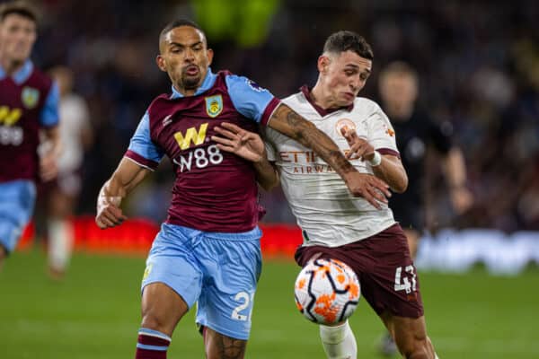 BURNLEY, ENGLAND - Friday, August 11, 2023: Burnley's Victor Alexander da Silva 'Vitinho' (L) challenges Manchester City's Phil Foden during the FA Premier League match between Burnley FC and Manchester City FC at Turf Moor. Man City won 3-0. (Pic by David Rawcliffe/Propaganda)