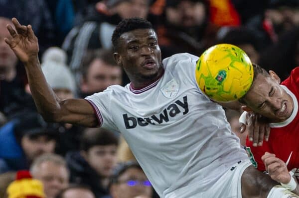 LIVERPOOL, ENGLAND - Wednesday, December 20, 2023: Liverpool's Kostas Tsimikas (R) is challenged by West Ham United's Mohammed Kudus during the Football League Cup Quarter-Final match between Liverpool FC and West Ham United FC at Anfield. (Photo by David Rawcliffe/Propaganda)