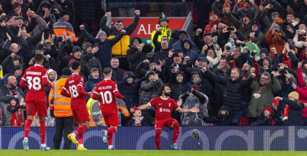LIVERPOOL, ENGLAND - Monday, January 1, 2024: Liverpool's Mohamed Salah sits on the LED advertising boards as he celebrates after scoring the fourth goal during the FA Premier League match between Liverpool FC and Newcastle United FC on New Year's Day at Anfield. Liverpool won 4-2. (Photo by David Rawcliffe/Propaganda)