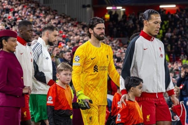 LIVERPOOL, ENGLAND - Tuesday, March 11, 2025: Liverpool's captain Virgil van Dijk (R) and goalkeeper Alisson Becker walk out with mascots past Etihad cabin crew before the UEFA Champions League Round of 16 2nd Leg match between Liverpool FC and Paris Saint-Germain FC at Anfield. The tie ended 1-1 on aggregate, PSG won 4-1 on penalties. (Photo by David Rawcliffe/Propaganda)