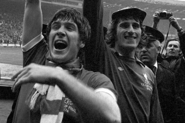 2DAW7RT File photo dated 05-05-1974 of Liverpool captain Emlyn Hughes (left) and goalkeeper Ray Clemence joyously show the FA Cup to the fans after Liverpools 3-0 victory.