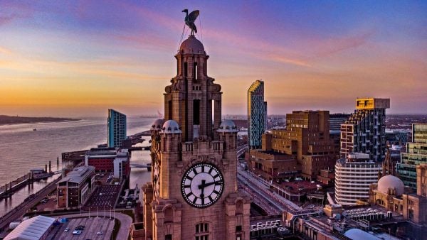 The sun sets behind the Royal Liver Building in Liverpool. Picture date: Wednesday March 17, 2021. (Photo: Peter Byrne / PA Images / Alamy)