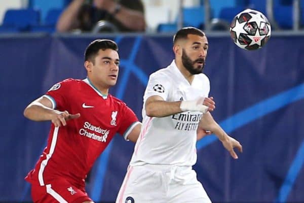 Liverpool's Ozan Kabak (left) and Real Madrid's Karim Benzema battle for the ball during the UEFA Champions League match at the Alfredo Di Stefano Stadium, Madrid. Picture date: Tuesday April 6, 2021.