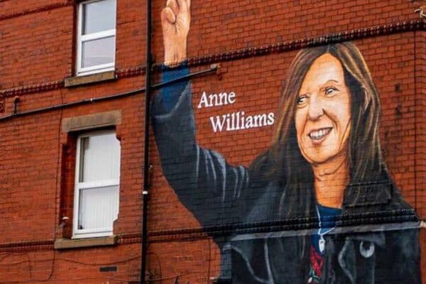 2GE9PH9 Artist Paul Curtis paints a mural of Anne Williams, the mother of Hillsborough victim Kevin Williams, on a building in the Anfield area of Liverpool. Picture date: Wednesday August 18, 2021.