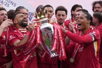Liverpool’s captain Virgil van Dijk, right, Mohamed Salah, center left, and teammates celebrate with the winner’s trophy after the English Premier League soccer match between Liverpool and Crystal Palace at the Anfield stadium in Liverpool, England, Sunda