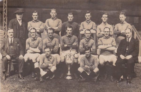 (Please credit within piece: The Bromilow family) Liverpool squad photo, including Jock McNab, Elisha Scott, Walter Wadsworth, Tom Bromilow, Dick Forshaw, manager David Ashworth, Ephraim Longworth and the First Division trophy, 1922