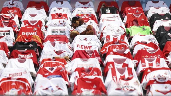 Shirts of fans unable to attend hang over the seats at the match between Cologne and Mainz (Lars Baron/AP)