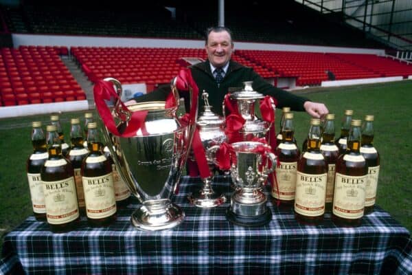 LIVERPOOL. ENGLAND. LFC manager Bob Paisley stands on the Anfield pitch, proudly displaying his haul from the 1980-81 season: The European Cup (v Real Madrid in final), League Cup (v West Ham in final), Liverpool Senior Cup (v South Liveprool in final), Central league Trophy (reserves) and 16 bottles of Bell's whiskey as manager of the month and other special season awards. (Getty Images)