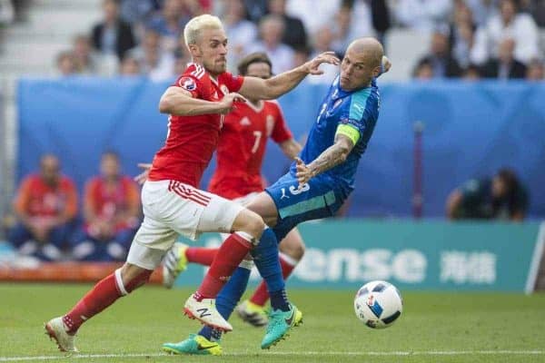 BORDEAUX, FRANCE - Saturday, June 11, 2016: Wales' Aaron Ramsey beats the challenge of Slovakia's Martin Skrtel to set up Hal Robson-Kanu (unseen) to score the second and winning goal during the UEFA Euro 2016 Championship at Stade de Bordeaux. (Pic by Paul Greenwood/Propaganda)