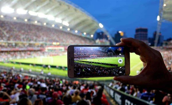 HONG KONG, CHINA - Wednesday, July 19, 2017: A supporter takes a photo on an iPhone during the Premier League Asia Trophy match between Leicester City and West Bromwich Albion at the Hong Kong International Stadium. (Pic by David Rawcliffe/Propaganda)