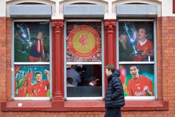 LIVERPOOL, ENGLAND - Sunday, October 7, 2018: A supporter walks past images of Liverpool legends in the window of the Albert Pub before the FA Premier League match between Liverpool FC and Manchester City FC at Anfield. (Pic by David Rawcliffe/Propaganda)