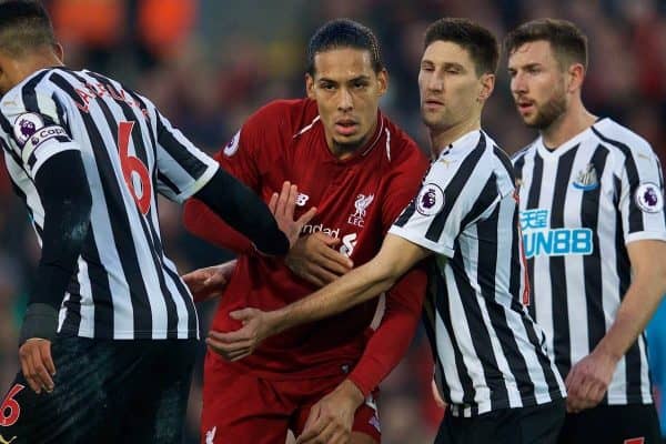 LIVERPOOL, ENGLAND - Boxing Day, Wednesday, December 26, 2018: Liverpool's Virgil van Dijk is held by Newcastle United's captain Jamaal Lascelles (L) and Federico Fernández during the FA Premier League match between Liverpool FC and Newcastle United FC at Anfield. (Pic by David Rawcliffe/Propaganda)